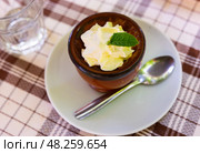 Delicate flan dessert is served in miniature bowl decorated with leaf of fragrant fresh mint. Стоковое фото, фотограф Яков Филимонов / Фотобанк Лори