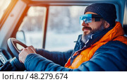 Winter Adventure: A driver with tech eyewear navigates a snowy landscape in their vehicle, bringing futuristic travel to cold climates. Стоковое AI-изображение, AI-художник Данила Большаков / Фотобанк Лори