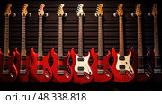 features red electric guitar ai generated. Стоковое AI-изображение, AI-художник Vectorwin / Фотобанк Лори