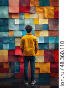 A person stands in front of a colorful wall adorned with sticky notes, reflecting on the artistic display in a creative environment. Стоковое AI-изображение, AI-художник Данила Большаков / Фотобанк Лори