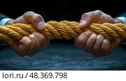 Hands exerting force on a sturdy yellow rope, showcasing the effort and determination in a tug-of-war competition as the sun sets. Стоковое AI-изображение, AI-художник Данила Большаков / Фотобанк Лори