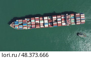 Cargo ship filled with containers in port area. Стоковое видео, видеограф Михаил Коханчиков / Фотобанк Лори