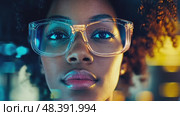 A confident person with curly hair and glasses stares directly into the camera while bright digital displays illuminate the urban environment at night, creating a captivating atmosphere. Стоковое AI-видео, аниматор Данила Большаков / Фотобанк Лори