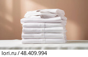 clothing white shirts stacked ai generated. Стоковое AI-изображение, AI-художник Vectorwin / Фотобанк Лори