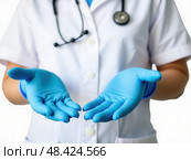 Doctors wear blue nitrile rubber gloves separately on a white background. Стоковое AI-изображение, AI-художник Sergey Grishin / Фотобанк Лори