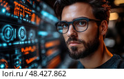 A young man focuses intently on digital data displayed on a high-tech screen, immersed in his work in the evening atmosphere. Стоковое AI-изображение, AI-художник Данила Большаков / Фотобанк Лори
