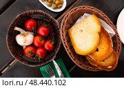 Kitchen table with cooking tools and fresh vegetables. Pan Con tomate, bread with tomato and garlic. Catalonian cuisine. Spain. Стоковое фото, фотограф Яков Филимонов / Фотобанк Лори