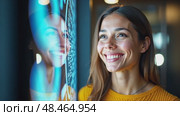 A woman smiling while interacting with a hologram, front view, bright lighting, friendly color palette with soft blues and yellows. future hi-tech interface communication concept. Стоковое AI-видео, аниматор Sergey Grishin / Фотобанк Лори