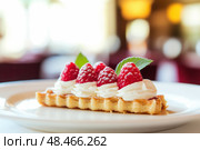 Appetizing raspberry tart and mint. Raspberry danish cake on plate on table and coffee. Tartlets raspberry fruit with vanilla custard, whipped cream served in a cafe. Blurred bokeh interior background. Стоковое AI-изображение, AI-художник Марина Демидюк / Фотобанк Лори