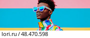 Summer portrait: A cool woman rocks color block style with mirrored blue sunglass for a fashion ad. Стоковое AI-изображение, AI-художник Данила Большаков / Фотобанк Лори