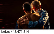 Остеопат проводит лечение мужчины. Черный фон. An osteopath treats a man. Black background. Стоковое AI-изображение, AI-художник Смирнова Светлана / Фотобанк Лори