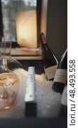 Russia, St.Petersburg, 24 April 2025: Several bottles of champagne brand Bonnet-Ponson are cooled in a niche with ice in the restaurant, local lighting, wine cabinet, decanters for sparkling wine. Редакционное видео, видеограф Vladimir Drozdin / Фотобанк Лори