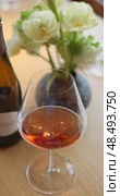 Russia, St.Petersburg, 24 April 2025: bottle of champagne is on table, flowers, wine glass in the restaurant, local lighting, wine cabinet, decanters for sparkling wine. Редакционное видео, видеограф Vladimir Drozdin / Фотобанк Лори