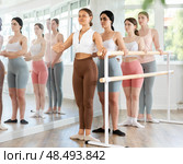 Young girl practicing first position holding by ballet barre. Стоковое фото, фотограф Яков Филимонов / Фотобанк Лори