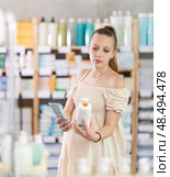 Young pregnant customer choosing cream in drugstore. Стоковое фото, фотограф Яков Филимонов / Фотобанк Лори