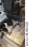 Russia, St.Petersburg, 24 April 2025: Several bottles of champagne brand Bonnet-Ponson are cooled in a niche with ice in the restaurant, local lighting, wine cabinet, decanters for sparkling wine. Редакционное видео, видеограф Vladimir Drozdin / Фотобанк Лори