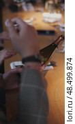Russia, St.Petersburg, 29 April 2025: Bottle of champagne brand Bonnet-Ponson is in the sommelier's hands in the restaurant, local lighting, wine cabinet, decanters for sparkling wine. Редакционное видео, видеограф Vladimir Drozdin / Фотобанк Лори