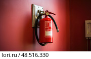 emergency fire extinguisher on wall ai generated. Стоковое AI-изображение, AI-художник Vectorwin / Фотобанк Лори