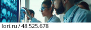Team of professionals inquisitively reviews statistical data projected on a large monitor in a modern office setting. Стоковое AI-изображение, AI-художник Данила Большаков / Фотобанк Лори