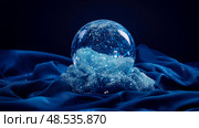 A festive snow globe resting on sapphire satin: Winter solstice dreamscape. Стоковое AI-изображение, AI-художник Данила Большаков / Фотобанк Лори