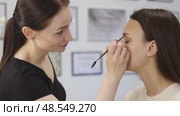 eyebrow coloring in beauty salon woman professional stylist dye brows brown tint. Стоковое видео, видеограф Olesia Kondrateva / Фотобанк Лори