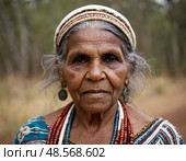 An elderly Aboriginal Australian woman stands confidently amidst a serene landscape Generative AI. Стоковое AI-изображение, AI-художник Юлия Петровская / Фотобанк Лори