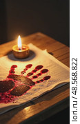 A close-up of a bloodied handprint on a white cloth, symbolizing sacrifice, illuminated by the dim glow of a single oil lamp. Стоковое AI-видео, аниматор Sergey Grishin / Фотобанк Лори