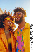 Golden Daydreams: Couple Joyful Summer Outing in Vivid Attire, Radiating Happiness and Connection Under the Bright Sky. Стоковое AI-изображение, AI-художник Данила Большаков / Фотобанк Лори
