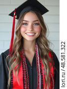 A smiling graduate in cap and gown showcases her joy during a graduation celebration, highlighting her academic success with a colorful sash. Стоковое AI-изображение, AI-художник Данила Большаков / Фотобанк Лори