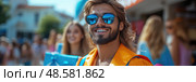 A young man wearing sunglasses enjoys his graduation day surrounded by friends, celebrating the accomplishment in a vibrant outdoor atmosphere. Стоковое AI-изображение, AI-художник Данила Большаков / Фотобанк Лори