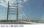SAINT PETERSBURG, RUSSIA - May 13, 2025: Video of movement of cars on Western High-Speed ​​Diameter WHSD and beautiful cable-stayed bridge across Petrovsky fairway of the Gulf of Finland on sunny day. Редакционное видео, видеограф Виктория Катьянова / Фотобанк Лори