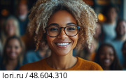 A joyful woman with curly hair and glasses beams with happiness in a bustling group setting, showcasing a warm and inviting atmosphere. Стоковое AI-изображение, AI-художник Данила Большаков / Фотобанк Лори