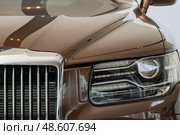 Aurus Komendant luxury premium SUV on display. Front right headlight. Close-up. Редакционное фото, фотограф Антон Вахрушев / Фотобанк Лори