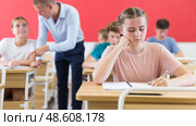 Young students sitting at desks in classroom. Стоковое фото, фотограф Яков Филимонов / Фотобанк Лори
