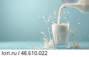 Pouring fresh milk into a clear glass with splashes against a blue background.  свежее молоко льется в прозрачный стакан с брызгами на голубом фоне. Стоковое AI-изображение, AI-художник Katsiaryna Repich / Фотобанк Лори
