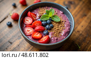 Strawberry and blueberry smoothie bowl with brown crumble topping and fresh mint leaves, healthy morning snack with rich color and nutrition. Стоковое AI-изображение, AI-художник Павел Муравьев / Фотобанк Лори