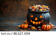 A Halloween-themed cauldron overflowing with assorted candies sits next to vibrant mini pumpkins, creating a cozy autumn atmosphere. Стоковое AI-изображение, AI-художник Данила Большаков / Фотобанк Лори