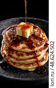 A stack of pancakes with syrup and butter on top. Стоковое AI-изображение, AI-художник Ярославский Максим / Фотобанк Лори