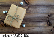 Christmas background. Gift and Christmas balls on a wooden background. Стоковое фото, фотограф Юлия Николаева / Фотобанк Лори