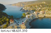 Picturesque village Assos by the turquoise sea at sunset in Kefalonia Island Greece. Стоковое видео, видеограф Igor Tichonow / Фотобанк Лори