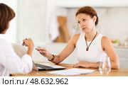 Female insurance agent tells woman the terms of property and life insurance. Стоковое фото, фотограф Яков Филимонов / Фотобанк Лори
