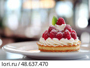 Appetizing raspberry tart and mint. Raspberry danish cake on plate on table and coffee. Tartlets raspberry fruit with vanilla custard, whipped cream served in a cafe. Blurred bokeh interior background. Стоковое AI-изображение, AI-художник Марина Демидюк / Фотобанк Лори