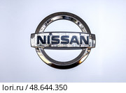 Nissan logo at the wall of car dealer's building. Nissan Motor Company Ltd is a multinational car manufacturer. Редакционное фото, фотограф FotograFF / Фотобанк Лори