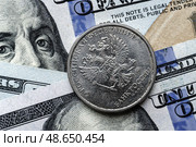 Close-up of Russian rubles coin on US 100 dollar bills in focus. Стоковое фото, фотограф Емельянов Евгений Викторович / Фотобанк Лори