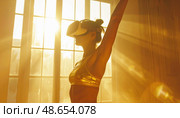 A woman practices yoga wearing VR headset in bright golden morning light, symbolizing future wellness trends and immersive digital exercise experiences. Стоковое AI-изображение, AI-художник Ольга Сухарева / Фотобанк Лори