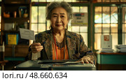 An elderly woman confidently submits her ballot at a bustling community polling station filled with activity. Стоковое AI-изображение, AI-художник Данила Большаков / Фотобанк Лори