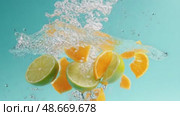 Limes and oranges splashing into water on turquoise background. Стоковое AI-видео, аниматор Юрий Поздников / Фотобанк Лори