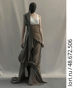This elegant asymmetrical evening gown features exquisite draped fabric detail, perfect for any formal occasion. Стоковое AI-изображение, AI-художник Anastasy Yarmolovich / Фотобанк Лори