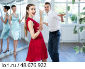 Couple in stage costumes learns boogie woogie dancing during individual lesson. Стоковое фото, фотограф Яков Филимонов / Фотобанк Лори