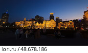 Shanghai, China – April 1, 2025: View of The Bund at night with historic colonial buildings illuminated along the Huangpu River in Huangpu District, full of visitors and city lights. Редакционное фото, фотограф Татьяна Терехина / Фотобанк Лори